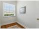 Compact office with hardwood flooring, a window for natural light, and neutral wall decor at 216 Hammock Oak Cir, Debary, FL 32713