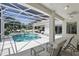 Screened-in pool and patio with lounge chairs offer a relaxing outdoor retreat at 216 Hammock Oak Cir, Debary, FL 32713