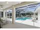 Screened-in pool area featuring a jacuzzi, lounge chairs, and bright natural light at 216 Hammock Oak Cir, Debary, FL 32713