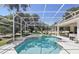 Outdoor pool and hot tub surrounded by a screened enclosure and lush landscaping at 216 Hammock Oak Cir, Debary, FL 32713