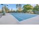 Well-maintained tennis court with benches and surrounding greenery at 216 Hammock Oak Cir, Debary, FL 32713