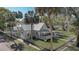 Aerial view showcases the property's fenced yard, mature trees, and appealing architectural style at 246 N Oak Ave, Orange City, FL 32763