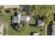 Bird's eye view of a home featuring lush landscaping, backyard fire pit, and detached garage with a gray metal roof at 246 N Oak Ave, Orange City, FL 32763