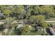 Charming home with well-manicured lawn, mature trees, and a white picket fence for a classic curb appeal at 246 N Oak Ave, Orange City, FL 32763