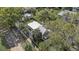 Aerial shot highlights the home's layout, showcasing its manicured lawn, trees and proximity to the street at 246 N Oak Ave, Orange City, FL 32763