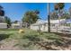 Beautifully landscaped backyard with a fire pit, white fence, and charming architecture create a serene outdoor space at 246 N Oak Ave, Orange City, FL 32763
