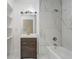 Modern bathroom with marble tile and shower/tub combination at 246 N Oak Ave, Orange City, FL 32763