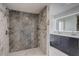 Bathroom featuring tiled walk-in shower with dual sink vanity at 246 N Oak Ave, Orange City, FL 32763