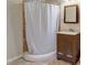 Bathroom features a shower with a curtain, vanity, and a mirror at 246 N Oak Ave, Orange City, FL 32763