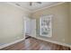 Bright bedroom featuring hardwood floors, neutral paint, ceiling fan, and natural light from the window at 246 N Oak Ave, Orange City, FL 32763