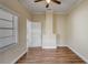 Bright bedroom featuring hardwood floors, neutral paint, ceiling fan, and natural light from the window at 246 N Oak Ave, Orange City, FL 32763