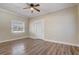Cozy bedroom featuring hardwood floors, natural light, and front door access at 246 N Oak Ave, Orange City, FL 32763