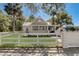 Attractive exterior of a home with a classic white fence, lush lawn, and well-maintained landscaping at 246 N Oak Ave, Orange City, FL 32763