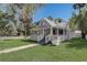 Charming home featuring a quaint porch, well-maintained lawn, and a classic gray exterior finish at 246 N Oak Ave, Orange City, FL 32763