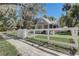 Charming home with white picket fence, mature trees, and well-manicured lawn for curb appeal at 246 N Oak Ave, Orange City, FL 32763