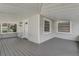 Inviting front porch featuring a painted gray wood floor and views of the landscaped front yard at 246 N Oak Ave, Orange City, FL 32763