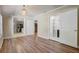 Open floor plan with hardwood floors leading to kitchen and bathrooms at 246 N Oak Ave, Orange City, FL 32763
