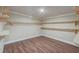 Walk-in closet features hardwood floors, neutral paint, recessed lighting, and wood shelves at 246 N Oak Ave, Orange City, FL 32763