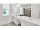 Bright bathroom with double vanity, large mirror, and shower, perfect for modern convenience and style at 2616 Calistoga Ave, Kissimmee, FL 34741