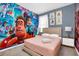 This bedroom features Disney themed wallpaper and decor at 2616 Calistoga Ave, Kissimmee, FL 34741