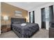 This modern bedroom includes an upholstered bed, modern lamps, and stylish window treatments at 2616 Calistoga Ave, Kissimmee, FL 34741