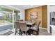 Elegant dining area with a modern table, seating for eight, and sliding glass doors to the lanai at 2616 Calistoga Ave, Kissimmee, FL 34741