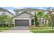 Charming two-story home with a well-manicured lawn and two car garage at 2616 Calistoga Ave, Kissimmee, FL 34741
