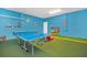 Bright game room featuring a ping pong table, TV, and playful décor, offering a fun and entertaining space at 2616 Calistoga Ave, Kissimmee, FL 34741