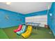 Fun game room features vibrant colors, ping pong table, and gaming chairs perfect for recreation and entertainment at 2616 Calistoga Ave, Kissimmee, FL 34741