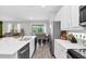 Kitchen with stainless steel appliances, a large island, and open layout to the living room at 2616 Calistoga Ave, Kissimmee, FL 34741