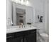 Modern bathroom features a floating vanity, framed mirror, and contemporary artistic accents at 2741 Serenity Meadow Dr, Kissimmee, FL 34744