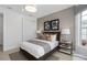 This bedroom boasts neutral colors, modern decor, a queen bed, and stylish side tables at 2741 Serenity Meadow Dr, Kissimmee, FL 34744