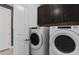 Laundry room features Whirlpool washer and dryer, cabinets, and a neutral color scheme at 2741 Serenity Meadow Dr, Kissimmee, FL 34744
