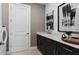 Convenient laundry room with sink, storage, and adjacent washer and dryer hookups at 2741 Serenity Meadow Dr, Kissimmee, FL 34744