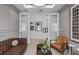 This living room features stylish decor, comfortable seating and glass french doors at 2741 Serenity Meadow Dr, Kissimmee, FL 34744