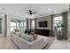 Open-concept living room with comfortable seating and sliding glass doors leading to outdoor space at 2741 Serenity Meadow Dr, Kissimmee, FL 34744
