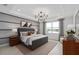 Bedroom features stylish furniture, tray ceilings, sophisticated decor and a beautiful view of the lake at 2741 Serenity Meadow Dr, Kissimmee, FL 34744