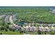 Beautiful aerial view of a suburban community with houses surrounded by trees and a tranquil lake at 2827 Moonstone Bnd, Kissimmee, FL 34758