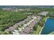 Scenic aerial view of the community homes nestled amongst lush trees and a serene lake at 2827 Moonstone Bnd, Kissimmee, FL 34758