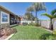 Well-manicured backyard with a spacious green lawn, lovely patio, and privacy fence, ideal for relaxation at 2827 Moonstone Bnd, Kissimmee, FL 34758