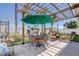 Backyard patio featuring a table, chairs, and a large shade umbrella at 2827 Moonstone Bnd, Kissimmee, FL 34758