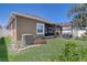 Expansive backyard featuring well-maintained lawn and a covered patio, perfect for outdoor entertaining at 2827 Moonstone Bnd, Kissimmee, FL 34758