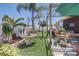 Inviting backyard oasis with lush landscaping, charming fountain, and pergola covered patio area at 2827 Moonstone Bnd, Kissimmee, FL 34758