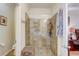Modern bathroom featuring a glass shower enclosure and tiled walls at 2827 Moonstone Bnd, Kissimmee, FL 34758
