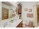 Bathroom with a double sink vanity, shower with tile surround, and decorative accents at 2827 Moonstone Bnd, Kissimmee, FL 34758