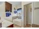 Bathroom featuring bathtub and wood cabinets and ample storage at 2827 Moonstone Bnd, Kissimmee, FL 34758