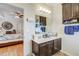 Bathroom with dual sink vanity and wood cabinets, plus a view to the main bedroom at 2827 Moonstone Bnd, Kissimmee, FL 34758