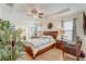 Spacious bedroom with tray ceiling, wood floors and large windows at 2827 Moonstone Bnd, Kissimmee, FL 34758