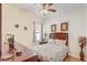 Cozy bedroom featuring a floral patterned bedspread, wood floors, and decorative wall art at 2827 Moonstone Bnd, Kissimmee, FL 34758