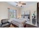 Well-lit bedroom with a dark wood bed frame, chair, and window at 2827 Moonstone Bnd, Kissimmee, FL 34758